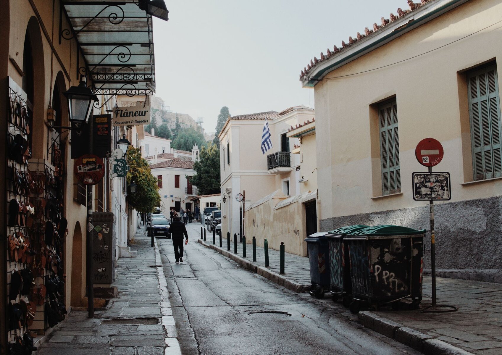 A quiet street with shops and traditional facades in Plaka, Athens